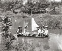 Four children in homemade sailboat